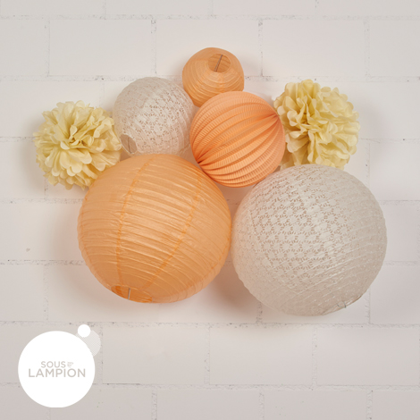 Peach and off-white paper lanterns for nursery decor