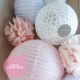 Pink nursery decor with paper lanterns and pompoms